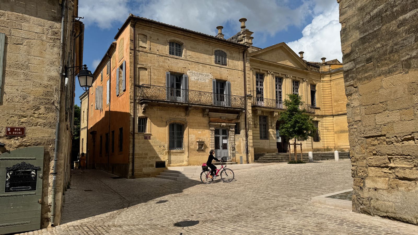 Rue calme d'Uzès, façades en pierre dorée